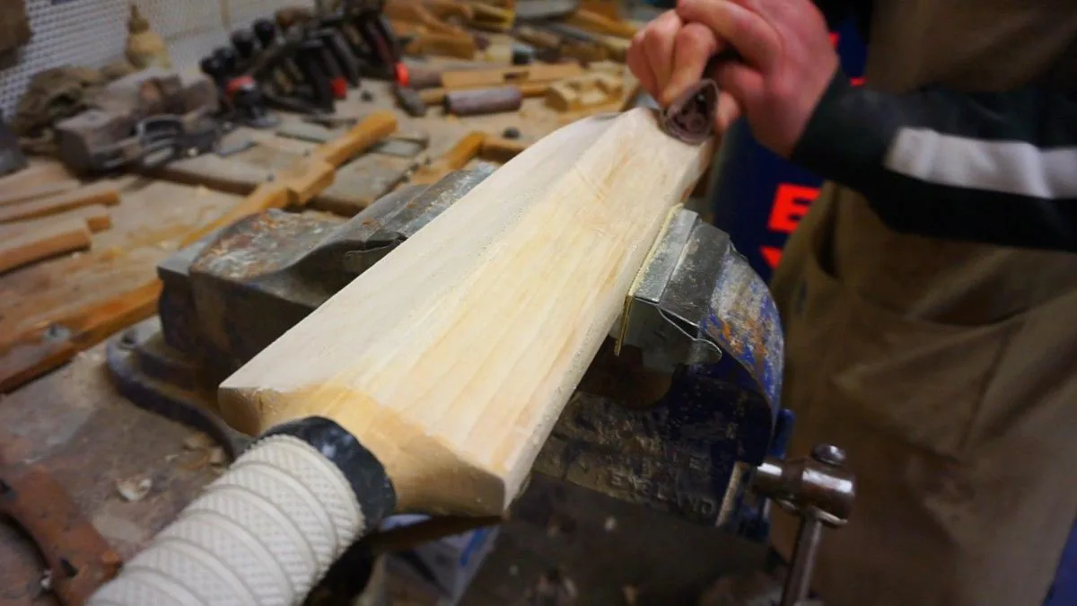 A blade held in a vise while it is planed