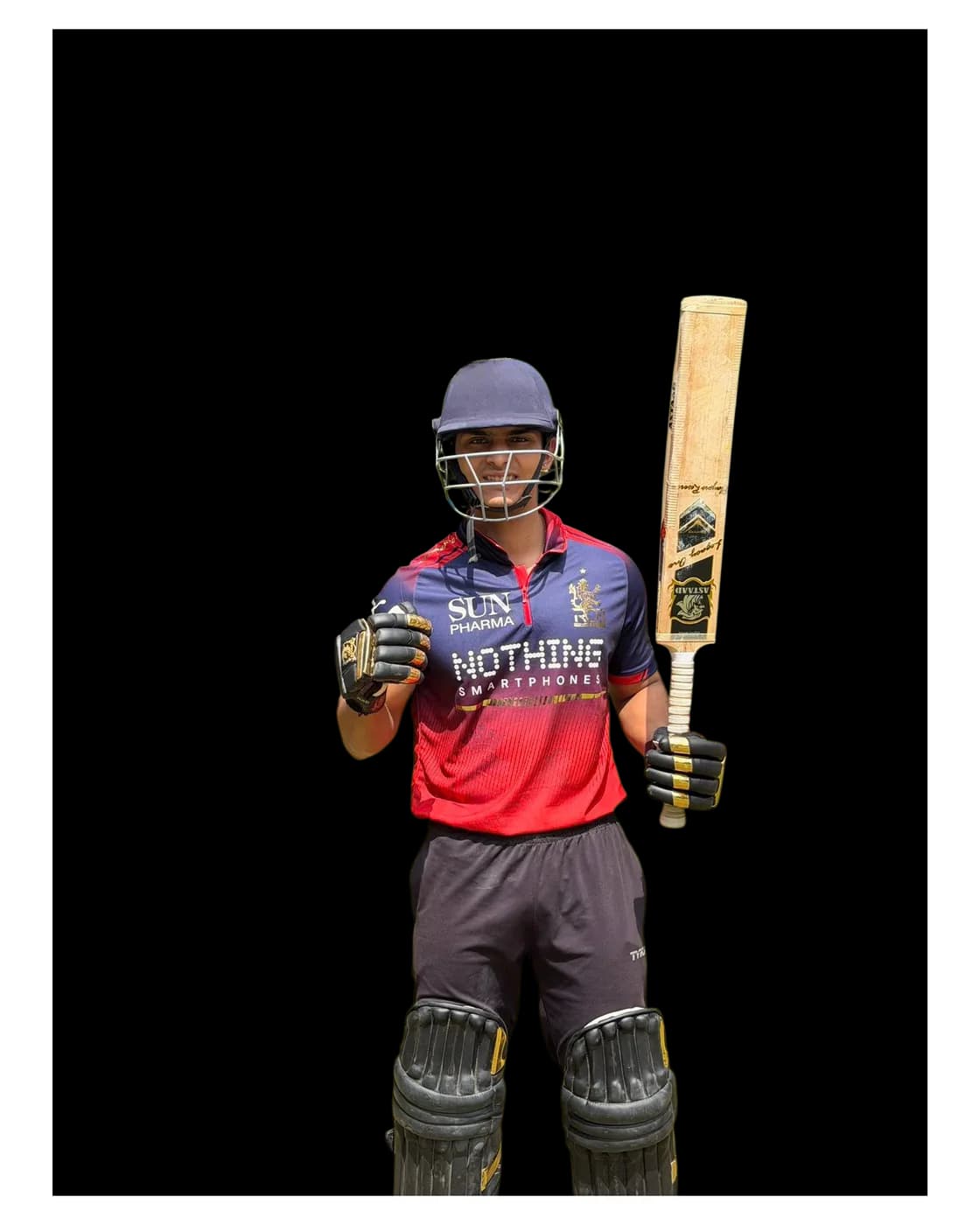 A young batter in helmet and pads raising an Astaad bat