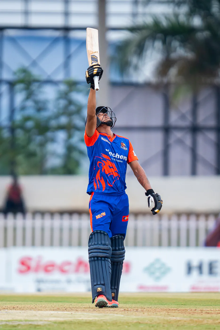 A batter raising an Astaad bat to celebrate