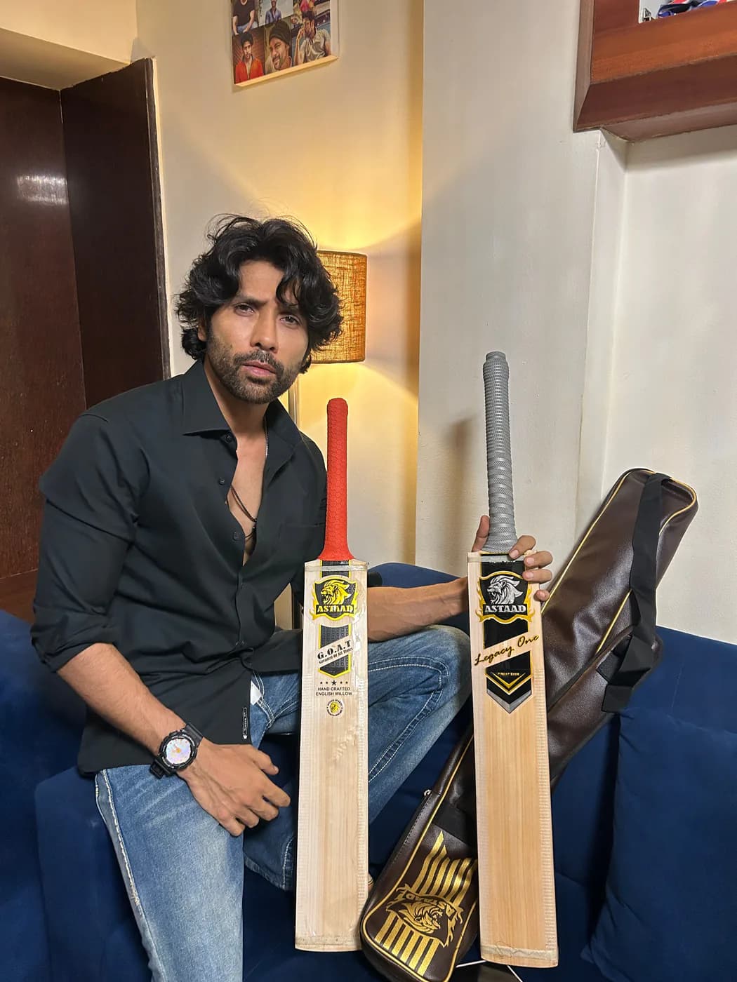 A player seated with two Astaad bats